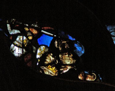 The west rose window depicting a scene from the Book of Revelation: War in heaven; St Michael conquers the dragon by French School