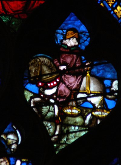 The west rose window depicting a scene from the Book of Revelation: A horseman carrying the scales to measure the wheat and barley by French School