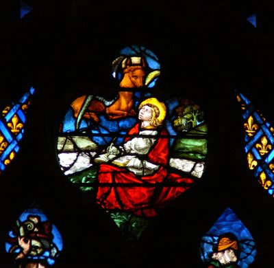 The west rose window depicting a scene from the Book of Revelation: Opening of the third seal, with the bull of St Luke by French School