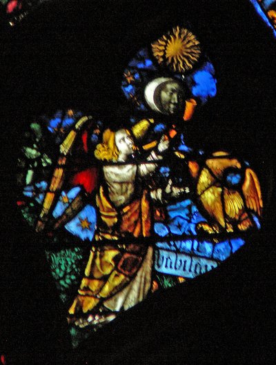 The west rose window depicting a scene from the Book of Revelation: Fourth trumpet sun, moon and stars darkening, and the eagle as the angel crying Woe, Woe by French School