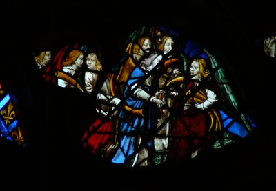 The west rose window depicting a scene from the Book of Revelation: Seven angels before God being given seven trumpets by French School