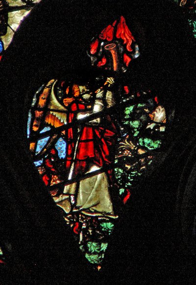 The west rose window depicting a scene from the Book of Revelation: Sounding of the first trumpet. Hail and fire descend by French School