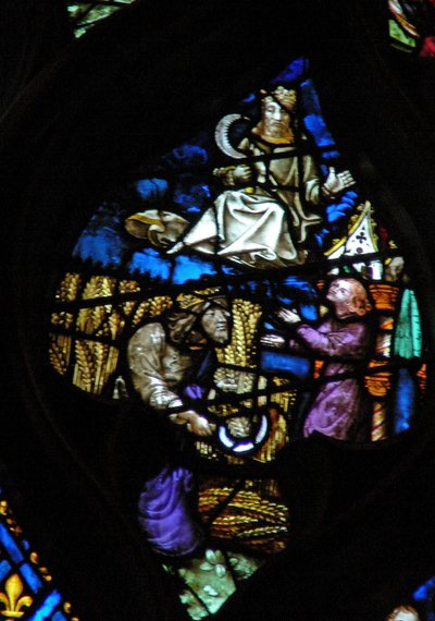 The west rose window depicting a scene from the Book of Revelation: Time of harvest. Son of man with a sickle on a white cloud by French School