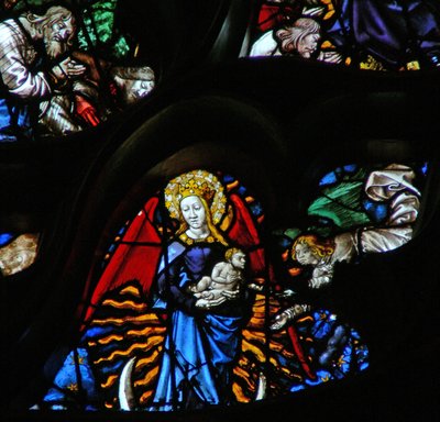 The west rose window depicting a scene from the Book of Revelation: Woman clothed as the sun, the moon under her feet and twelve stars in her nimbus by French School