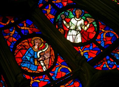 Window w141 depicting a musician angel with a harp and other angels by French School