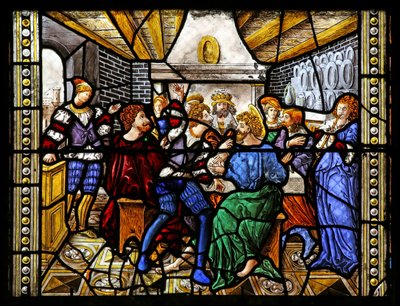 Window depicting St Thomas in India is invited to the wedding of Pelagius, is beaten by a servant who is in turn eaten by a lion. A dog brings in the servant