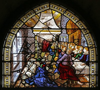 Window depicting St Thomas in India is invited to the wedding of Pelagius, is beaten by a servant who is in turn eaten by a lion. A dog brings in the servant