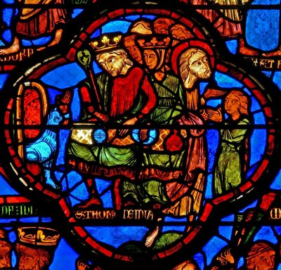 Window w16 depicting a scene from the life of St Thomas: the saint at a marriage banquet for the daughter of the king of India has his face slapped by a cupbearer: a lion removes his arm; Thomas restores it by French School