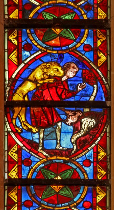 Window w213 depicting a scene from the life of St Thomas: a lion attacks the cupbearer as he collects water and removes his arm by French School