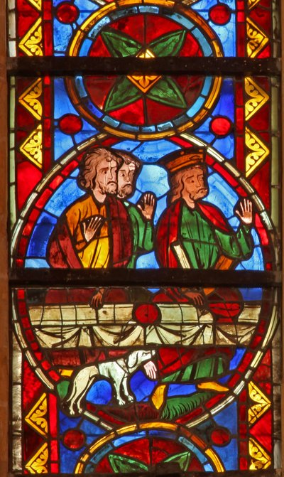 Window w213 depicting a scene from the life of St Thomas: at the banquet a dog brings in the cupbearer
