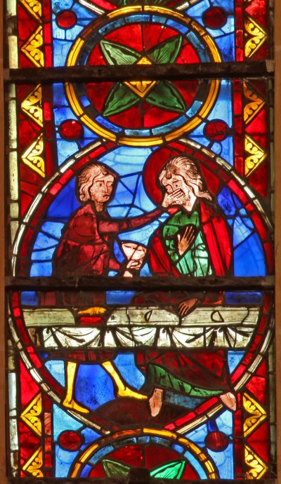 Window w213 depicting a scene from the life of St Thomas: the saint at a marriage banquet for the daughter of the king of India has his face slapped by a cupbearer by French School
