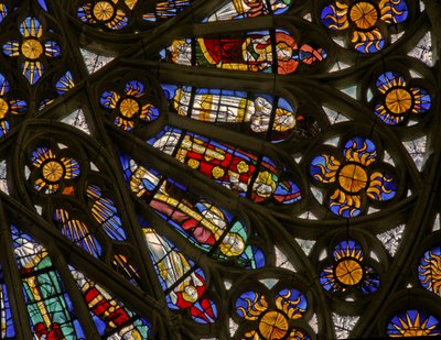Window depicting suns and bishops beneath the Angelic Hierarchy in the north rose window by French School