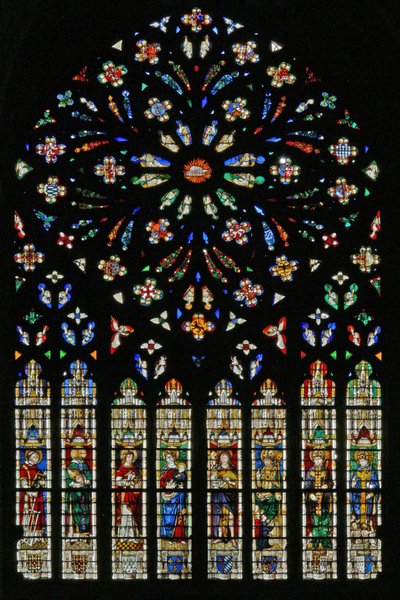 Window w237, the west rose window, depicting the Lamb of the Apocalypse at the center surrounded by 12 angel musicians; coats of arms that include Montmorency-Laval, Bertrand Duguesclin and Oli by French School