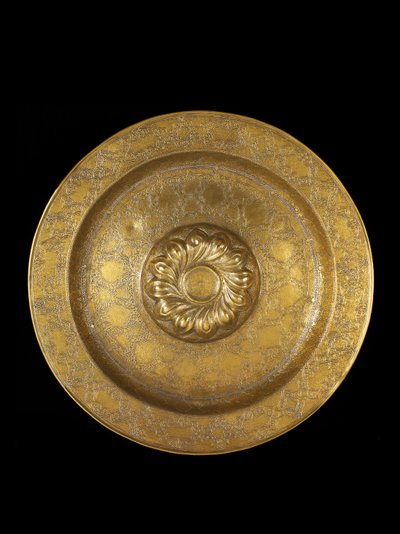 Dish of engraved brass with silver inlay, the central medallion encircled by repousse spiral gadroons, 1500-1525 by German School