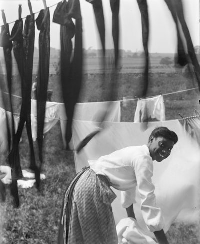 A Young African American Woman Hanging Laundry to Dry in Newport, Rhode Island, c.1902 by Gertrude Käsebier