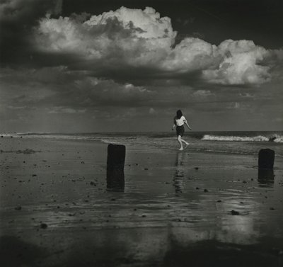 Kid playing with the waves at the beach by Godfrey Macdominic