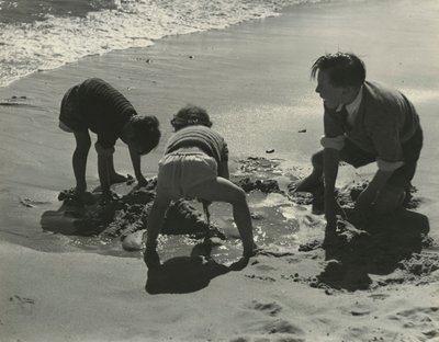 Three kids playing with sand at the beach by Godfrey Macdominic