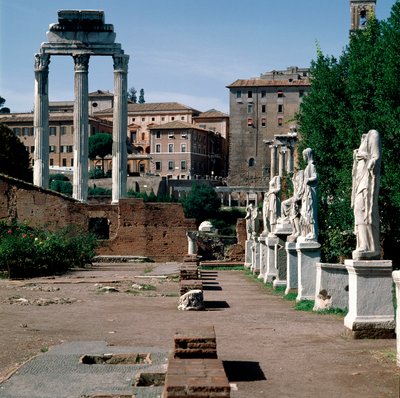 Roman Forum: statues of vestals. House of vestals (Casa delle Vestali or Atrium Vestae). On the left, the Greek temple of Dioscures (or temple of Castor and Pollux) (5th century BC). Rome by Greek or Roman