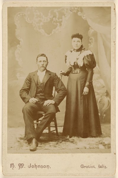 Unidentified couple: man with moustache seated, woman standing by H. M. Johnson