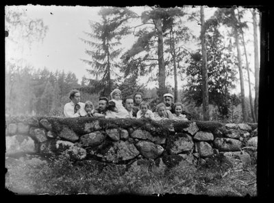 Hugo Simberg with Siblings on a Stone Wall by Hugo Simberg