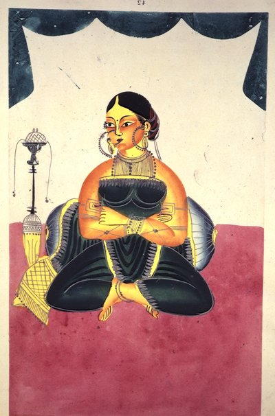 A Courtesan seated cross-legged beside a 