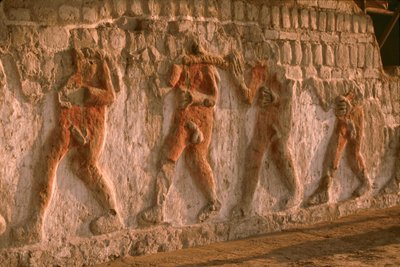Frieze of naked prisoners of the Moche on the Huaca Cao Viejo walls in El Brujo by Ira Block