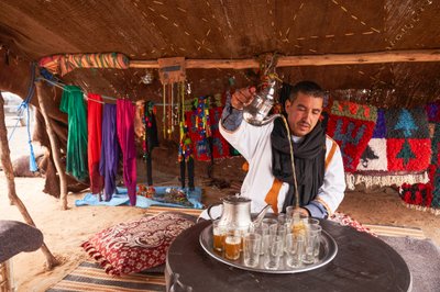 A local serving mint tea at Erg Chebbi in the desert near Merzouga, Morocco (photo) by Ira Block