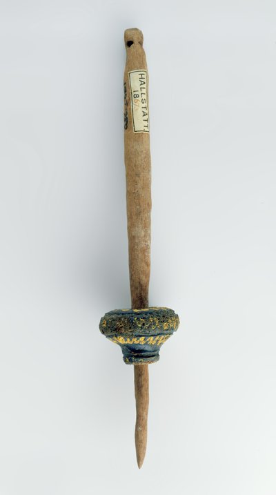 Spindle whorl with its surviving wooden spindle (from Hallstatt, Iron Age) by Iron Age