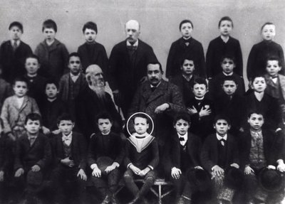 Benito Mussolini in elementary school - A portrait of Benito Mussolini with classmates and some teacher by Italian Photographer