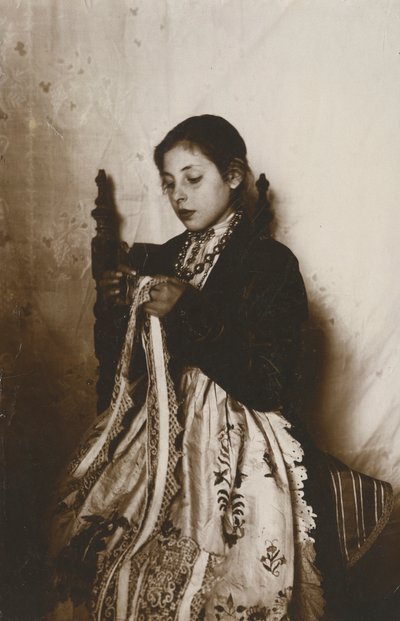 Young woman sewing, Tuscany, Italy, circa 1910 by Italian Photographer