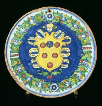 Maiolica plate bearing the Medici coat of arms with a border of foliage and fruit, Italian, 16th century by Italian School