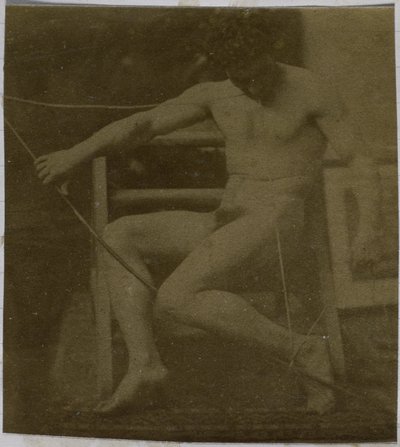 Study of a male nude model, sitting on a step, seen from the front with rope and bow on lap, in the studio of Jacques de Lalaing by Jacques Lalaing (attributed to)