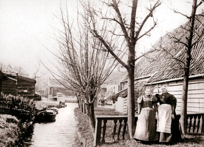 Two women on a canal bank, Broek, Netherlands by James Batkin
