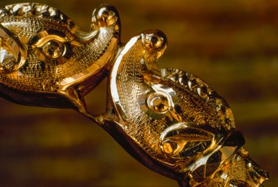 Hand crafted gold bracelet featuring two shark heads colliding by James L Stanfield