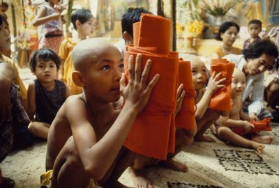 A Young Boy with Shaved Head Receives His Monk Clothing, Mandalay, Burma by James L Stanfield