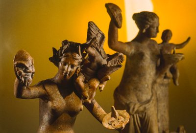 Terra-cotta sculptures of Aphrodite with winged Eros on her shoulder. Veria, Macedonia, Greece by James L Stanfield