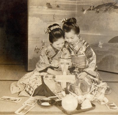 Japanese girls using a stereoscope viewer with stereographic cards by Japanese School