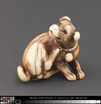 Netsuke modeled as a dog scratching its neck by Japanese School