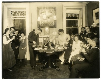 Alice Foote MacDougal entertaining a group of sailors in her small apt in Old War, Greenwich Village, New York, USA, c.1917-18 by Jessie Tarbox Beals
