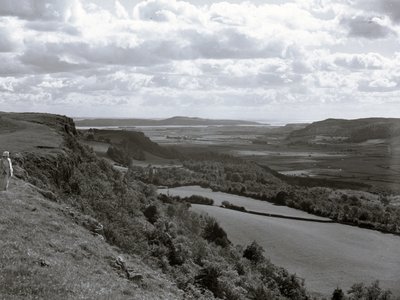 A lady on a hillside looking across the landscape at Scout Scar by Joseph Hardman
