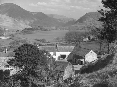 A view of a farm in the foreground with a lake and hills in the background by Joseph Hardman