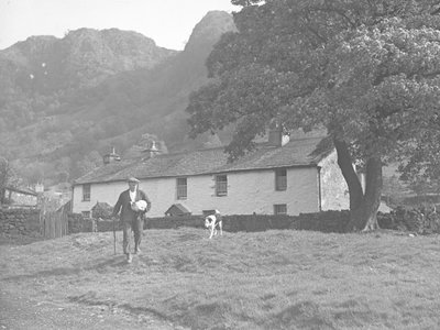 Farmer with lamb under arm and dog following by Joseph Hardman