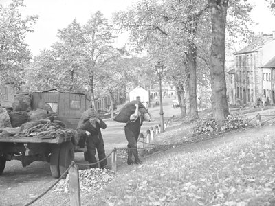 Lorry on Street with Two Coalmen Carrying Sacks of Coal by Joseph Hardman