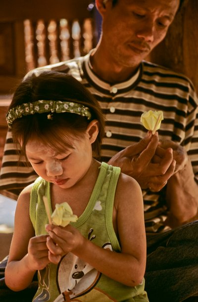 HIV Positive Father and Daughter Making Paper Flowers, 2002 by Karen Kasmauski