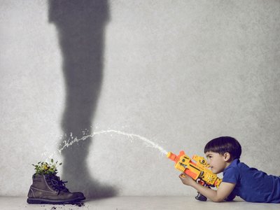 Boy Waters Plant Shadow by Karim Aboukelela