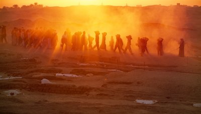 Workers labor to carry materials at archaeological excavation at Abydos, 2005 by Kenneth Garrett