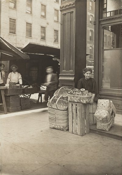 Lena Lochiavo - 11 years old, basket (and pretzel) seller, at Sixth Street Market in front of saloon entrance, Cincinnati, Ohio by Lewis Wickes Hine
