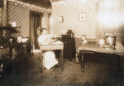 Woman inserting bristles into tooth brushes in her kitchen, c.1912 by Lewis Wickes Hine