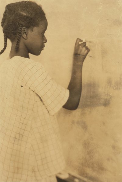 Young Girl Writing on Chalkboard in Classroom, Pleasant Green School, Marlinton, Pocahontas County, West Virginia, USA c.1921 (sepia photo) by Lewis Wickes Hine
