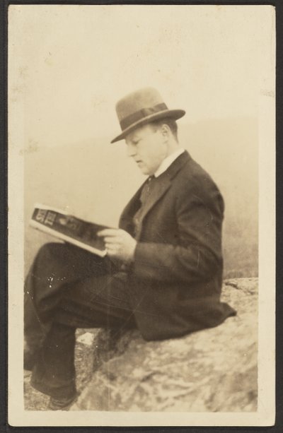 Man Reading Magazine on Rock by Louis Fleckenstein